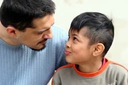 a young man talking with his son