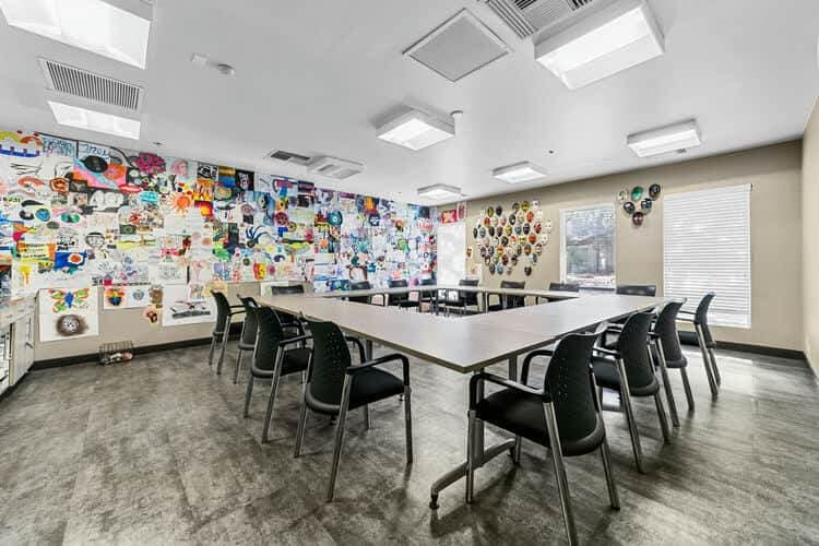 chairs and table with art on wall