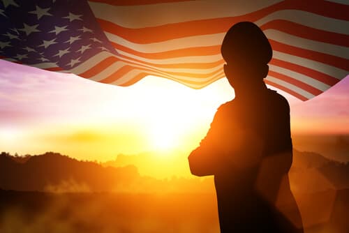 Silhouette of veteran with flag